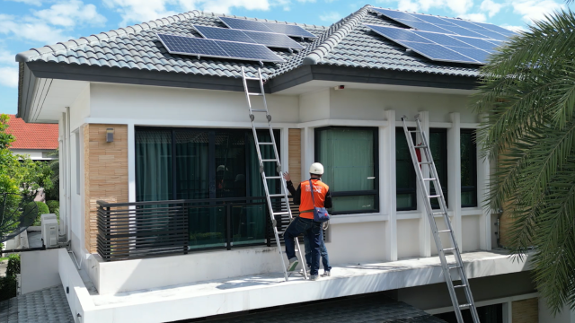 Workers installing a rooftop solar system.